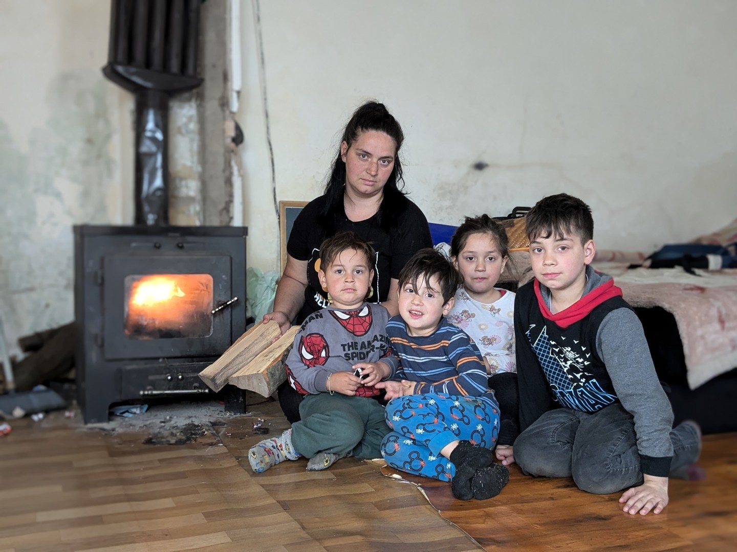 The Cikaric family stay close to the wood-burning stove to stay warm in the winter